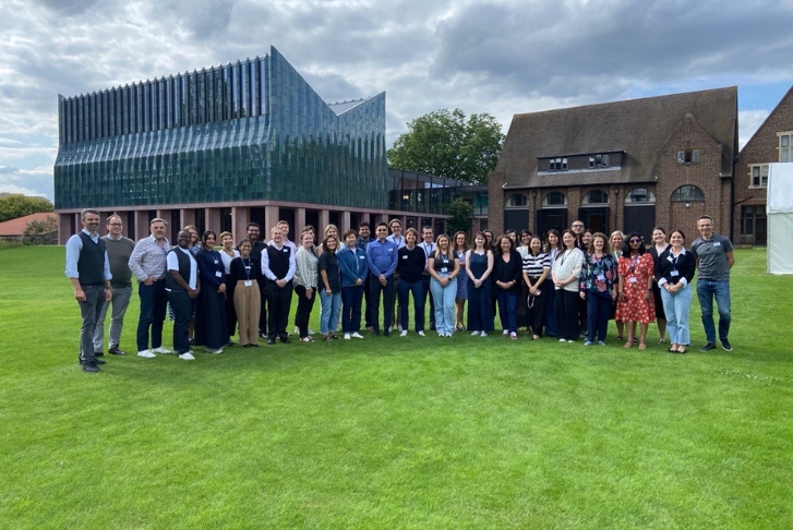Student group photo at Homerton College PCSB workshop July 24 Students standing in a semi-circle for a group photo in front of Homerton College PCSB workshop July 24