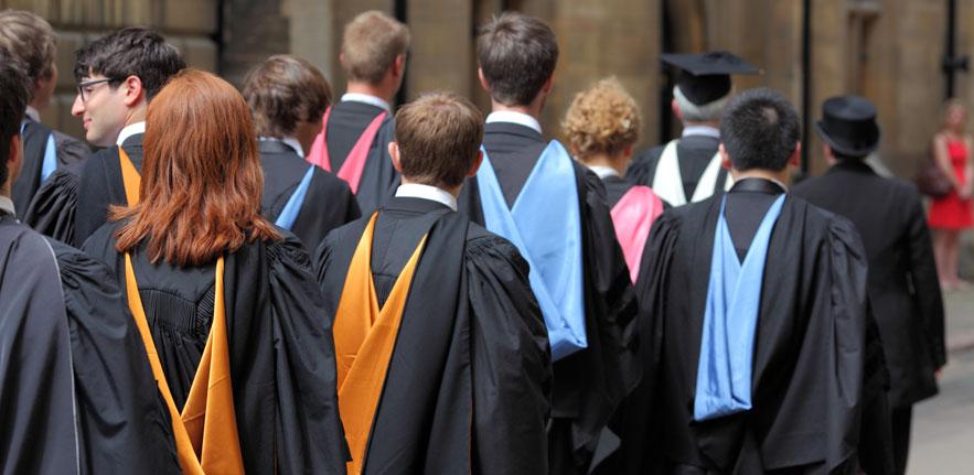 A group of University of Cambridge students wearing graduation robes. 