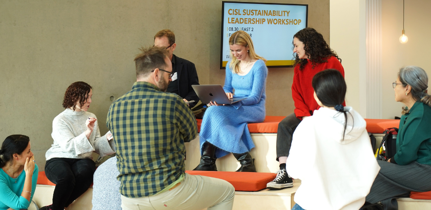 Sustainability Leadership students A group of students sat and stood around tiered seating